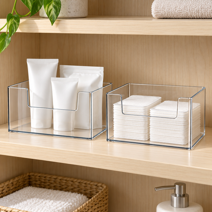 Clear boxes holding plain toiletry pouches and cotton pads