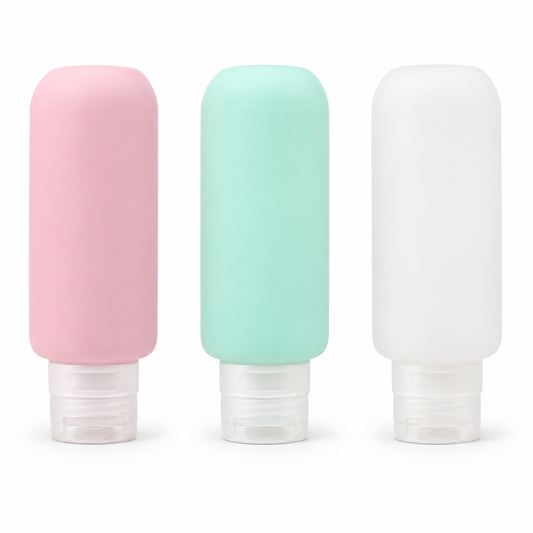 Three empty silicone bottles in pink mint and milky white