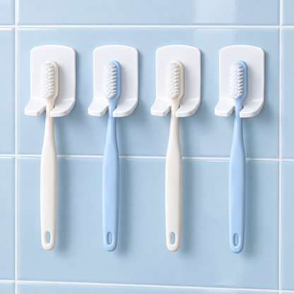 Four holders supporting plain manual toothbrushes on smooth tiles