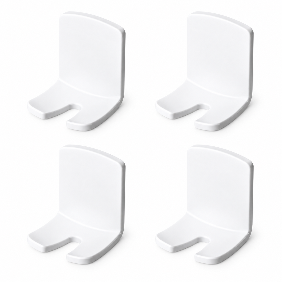 Four empty white adhesive toothbrush holders