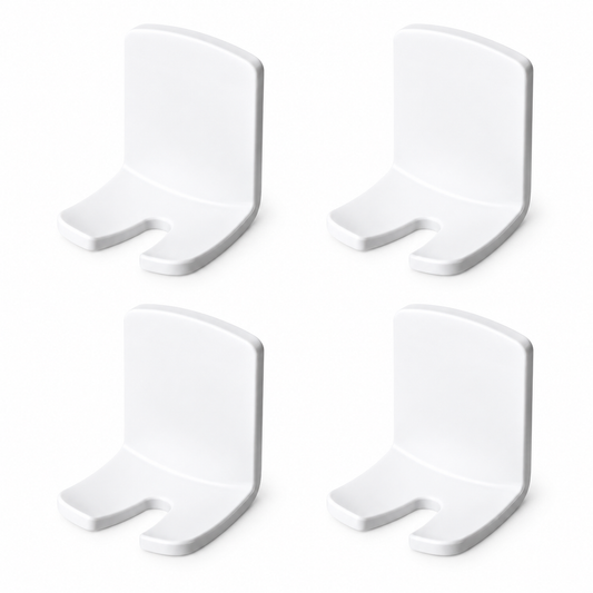 Four empty white adhesive toothbrush holders